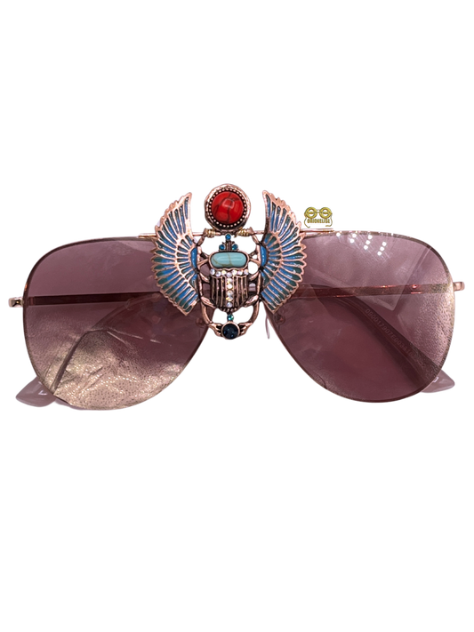 "Elegance" fashion eyewear by Orion Elise. Rose gold wire arm glasses with captivating Egyptian Scarab focal point. Bold aesthetic exudes confidence and self-assuredness. Elevate your look and attitude with these custom design glasses.