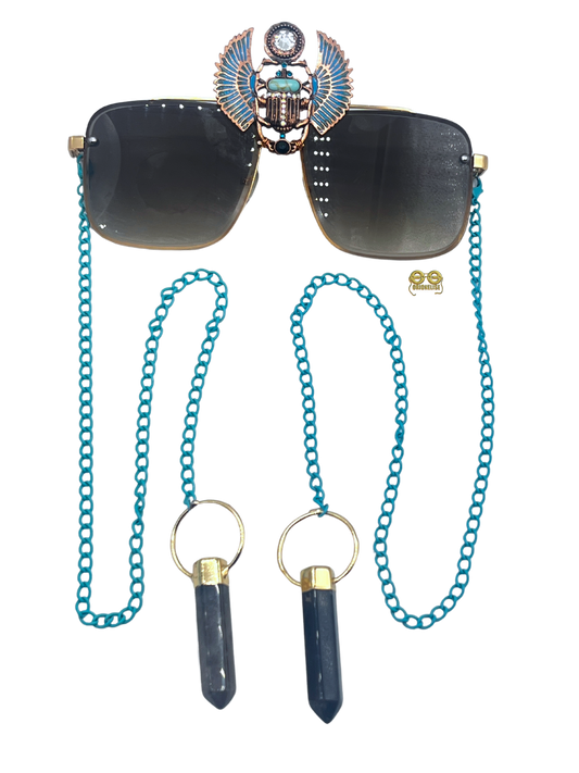 "On Purpose" Custom Wearable Design by Orion Elise. Gold/brown frame glasses with blue chain link and Egyptian Scarab focal point. Each end adorned with polished tourmaline stone for a touch of mystique and allure.